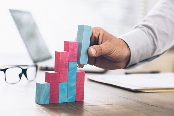 Businessman building a successful financial graph